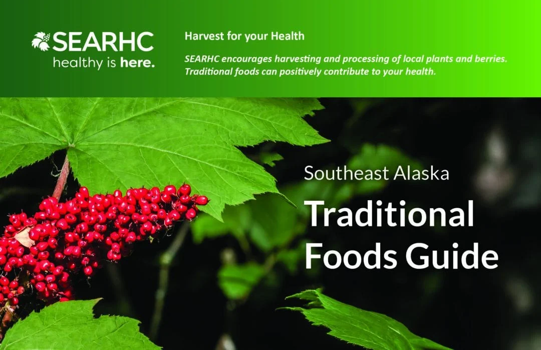 Cover of the 'Southeast Alaska Traditional Foods Guide' featuring a cluster of bright red berries and large green leaves, with the SEARHC logo and text.